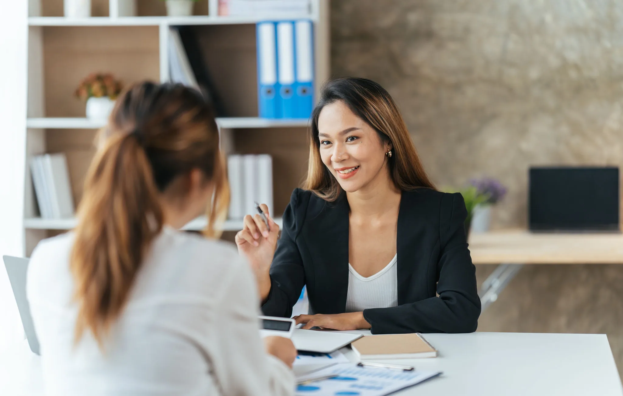 a team of technology professionals collaborating in a dark office around a computer monitor